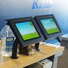 Two black iPad tablet mounted on a desktop, side by side