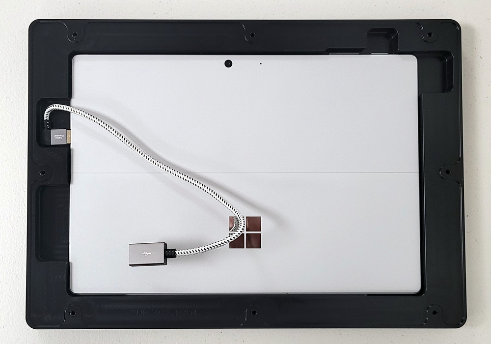 back of a Microsoft Surface Pro tablet in black case with braided USB-C cable