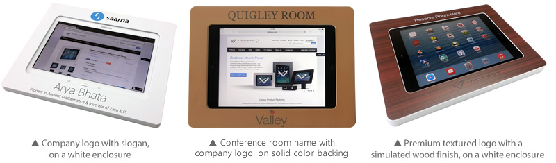 White digital kiosk with company logo and slogan, showcasing a web page about Arya Bhata; brown digital kiosk with conference room name Quigley Room and company logo, displaying the home page of a website; digital kiosk with a simulated wood finish featuring a premium textured logo, displaying a tablet home screen with various apps.
