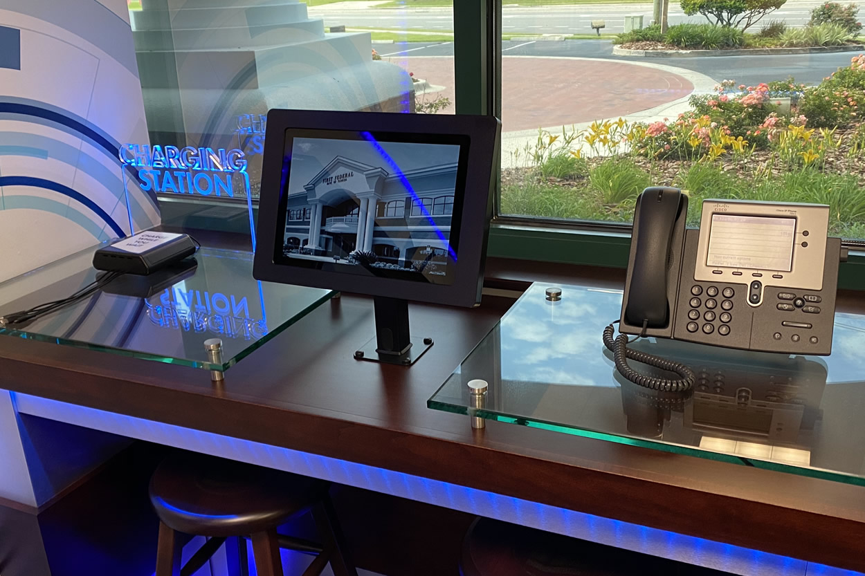 modern workstation with tablet, phone, and charging station displayed