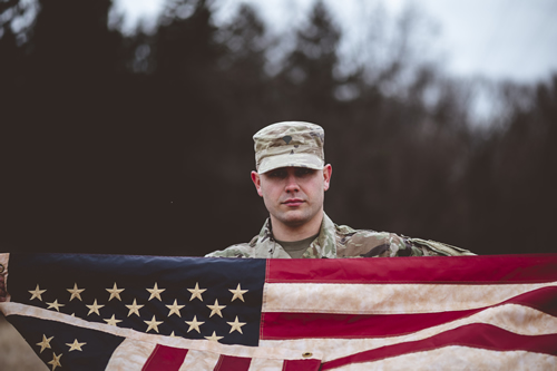 American soldier holding the us flag